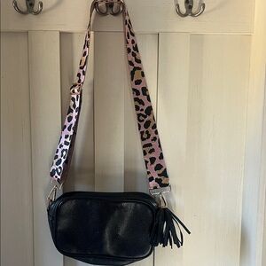 Black pebbled crossbody bag with guitar strap